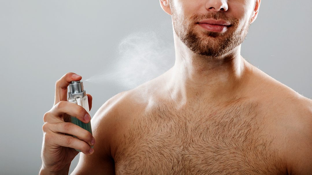 portrait handsome half naked man spraying perfume scaled